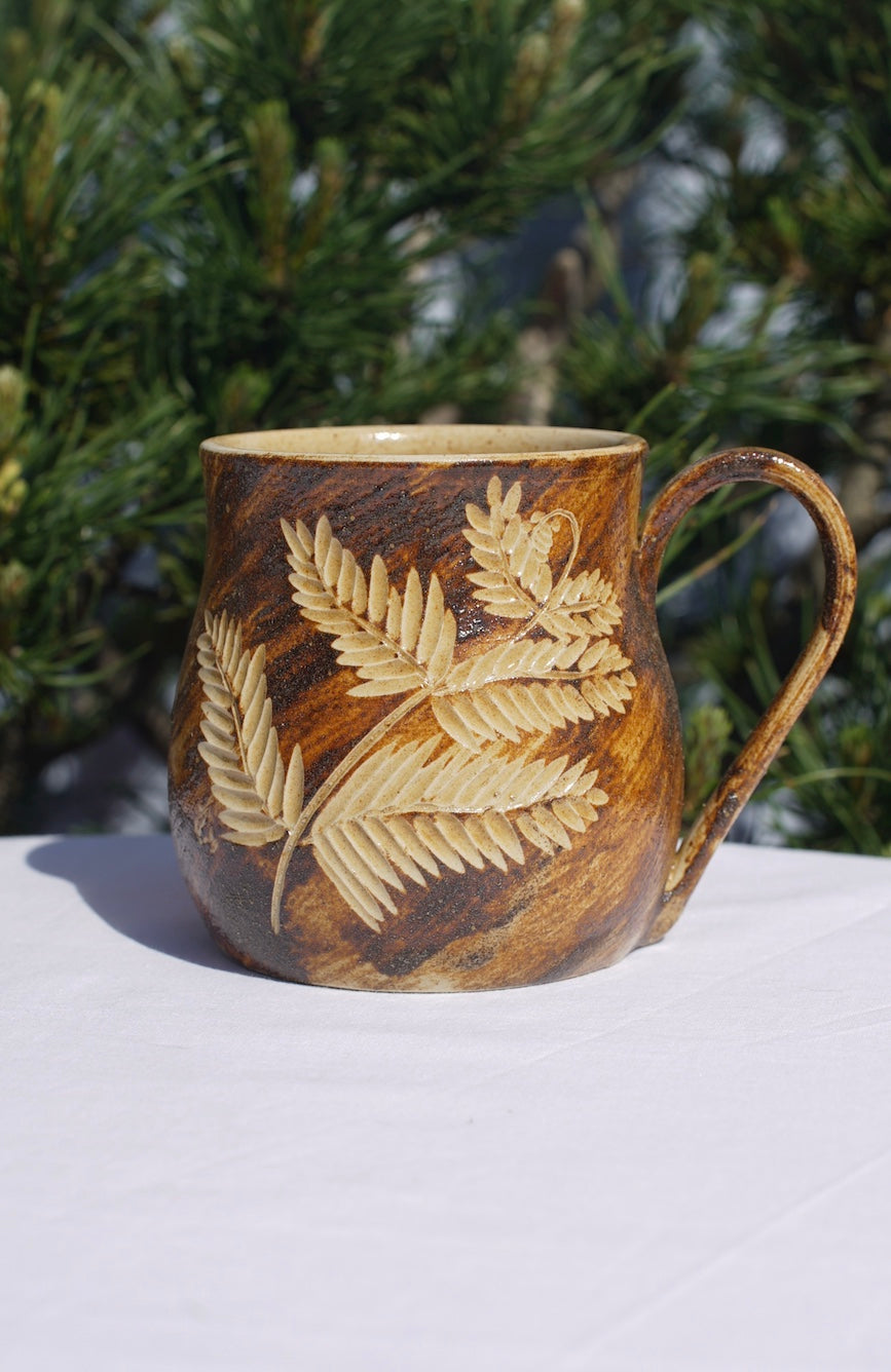 Cup of fern with healing clay